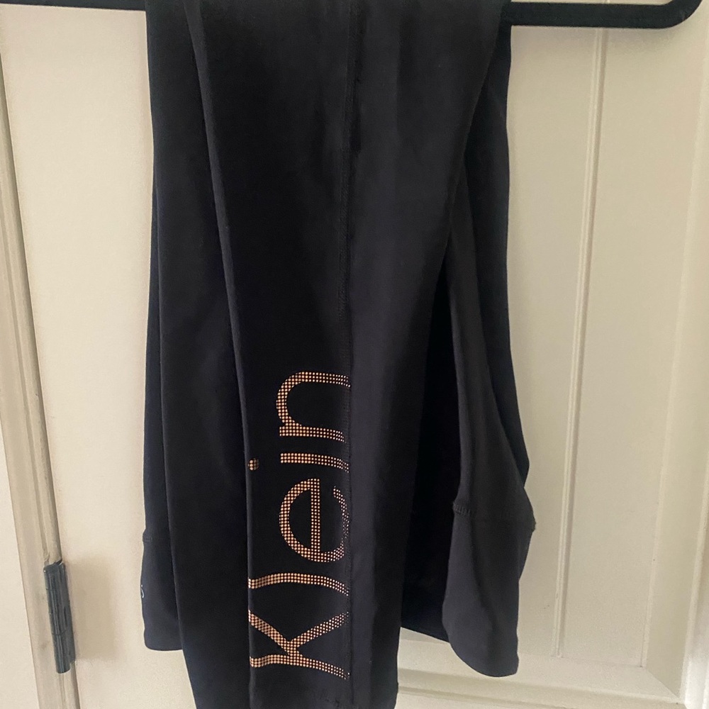 Black Calvin Klein leggings with rust color writing on leg
